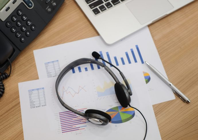 close-up-blurred-of-headset-of-call-centre-at-computer-office-room-with-financial-report-concept-